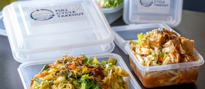 Reusable take out containers filled with food.