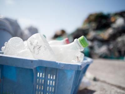 A laundry basket filled with plastic bottles.