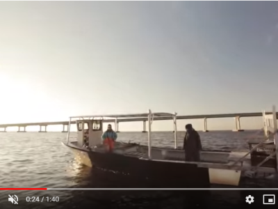 Two crab fishermen on a boat.