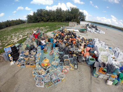 People sitting on a large pile of debris.