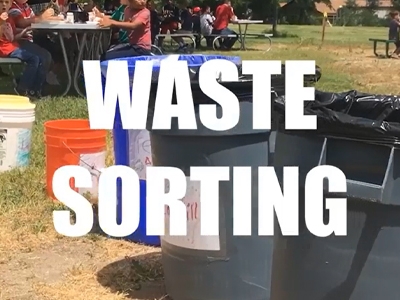Recycling and waste bins on a schoolyard.