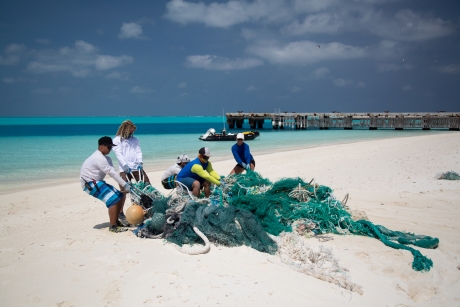 The 2016 marine debris removal team pulls a derelict net mass.
