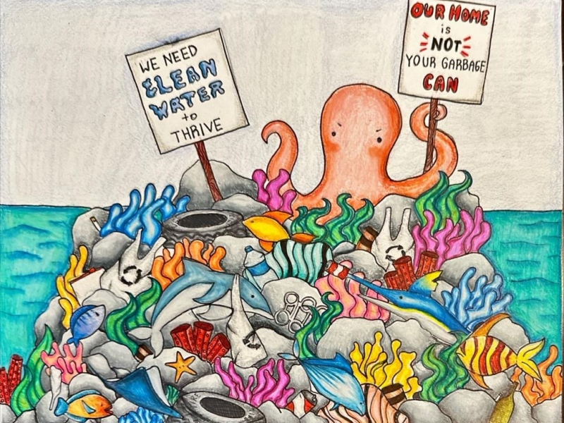 A drawing of a coral reef full of sea creatures and trash, with an octopus at the top holding two signs reading "We need clean water to thrive" and "Our home is not your garbage can," artwork by Sahini K. (Grade 6, Florida), winner of the Annual NOAA Marine Debris Program Art Contest. 